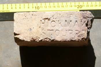 Large piece of firebrick with makers name stamped on the face.